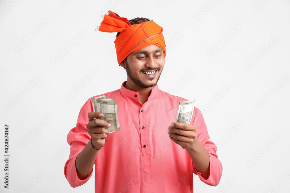 Young Indian farmer posing with currency on white background. Young Indian farmer posing with currency on white background.