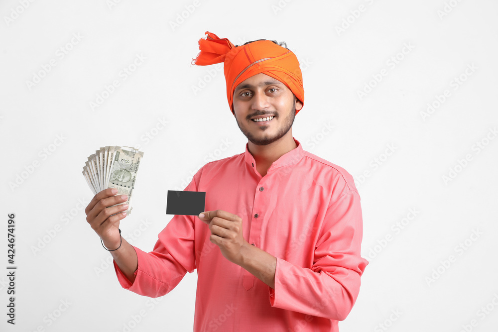 Young Indian farmer posing with currency on white background. Young Indian farmer posing with currency on white background.