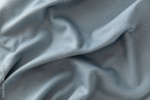 wrinkled surface of soft pale blue fleece, background, texture