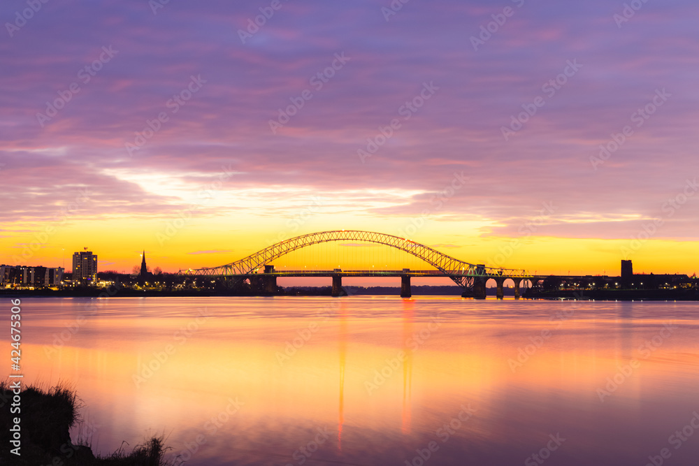 Silver Jubilee Bridge in Runcorn with the sun setting in the background