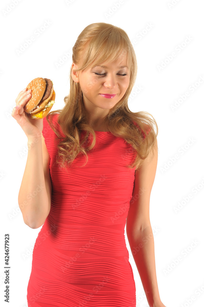 Young beautiful woman with some shopping bags and hamburger isolated on white Young beautiful woman with some shopping bags and hamburger isolated on white