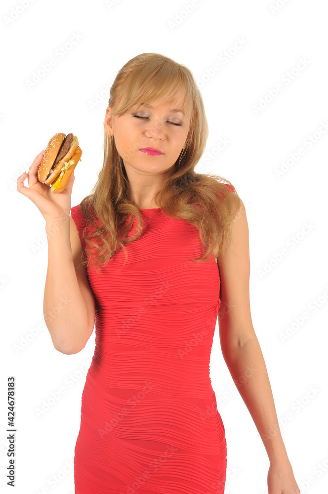 Young beautiful woman with some shopping bags and hamburger isolated on white Young beautiful woman with some shopping bags and hamburger isolated on white