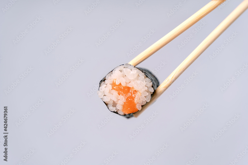 Simple rice and salmon rolls with chopsticks Simple rice and salmon rolls with chopsticks