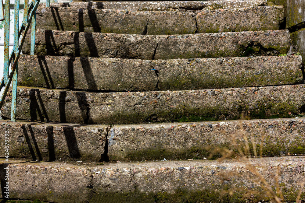 Dangerous emergency steps on an abandoned staircase. Concrete staircase in an abandoned house. Dangerous emergency steps on an abandoned staircase. Concrete staircase in an abandoned house.