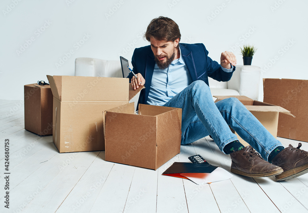 Business man picking up cardboard boxes and moving to a new place lifestyle Business man picking up cardboard boxes and moving to a new place lifestyle