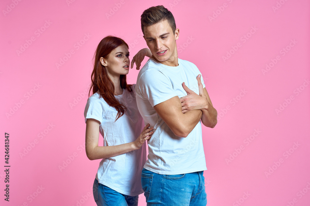 Man woman in white t-shirts hugs family romance pink background Man woman in white t-shirts hugs family romance pink background