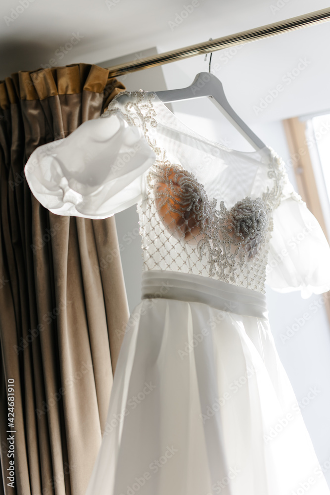 white wedding dress hanging on a hanger white wedding dress hanging on a hanger