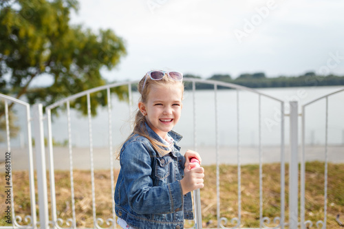 Little smiling girl outdoors portrait. Carefree chidhood photo