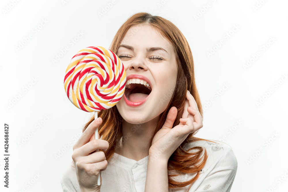 woman with multicolored lollipop near face cropped view of sweets emotion with open mouth