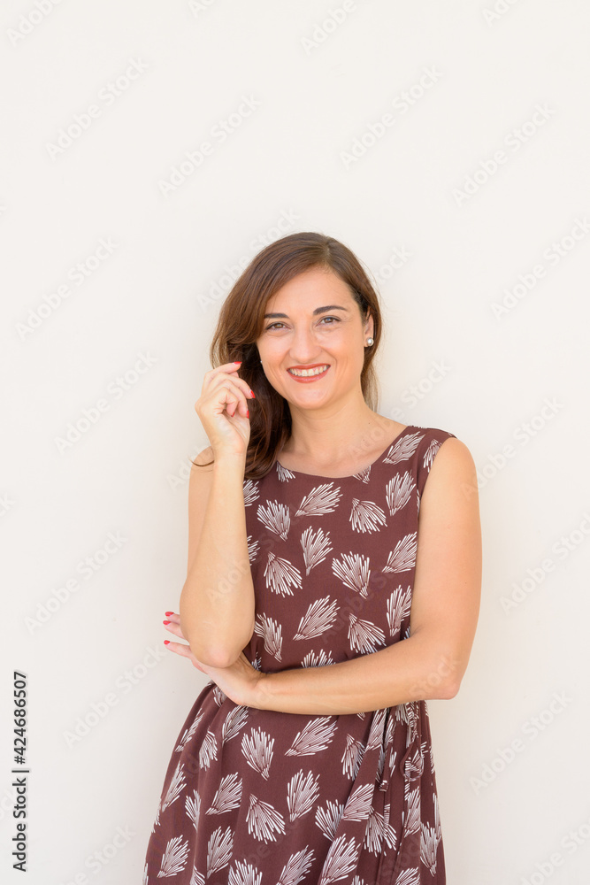 Portrait of beautiful woman smiling outdoors againt plain wall vertical shot Portrait of beautiful woman smiling outdoors againt plain wall vertical shot