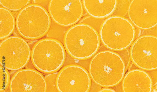 Natural background of sliced round oranges - top view