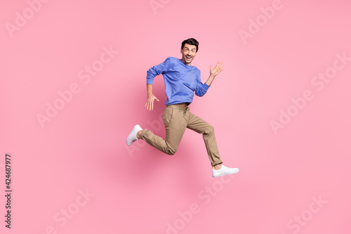Full body profile side photo of charming funny man run empty space excited sale isolated on pink color background