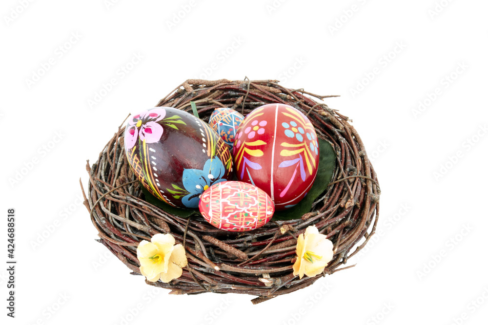 Easter egg decor on isolated on white background. Nest with handmade painted eggs pattern.