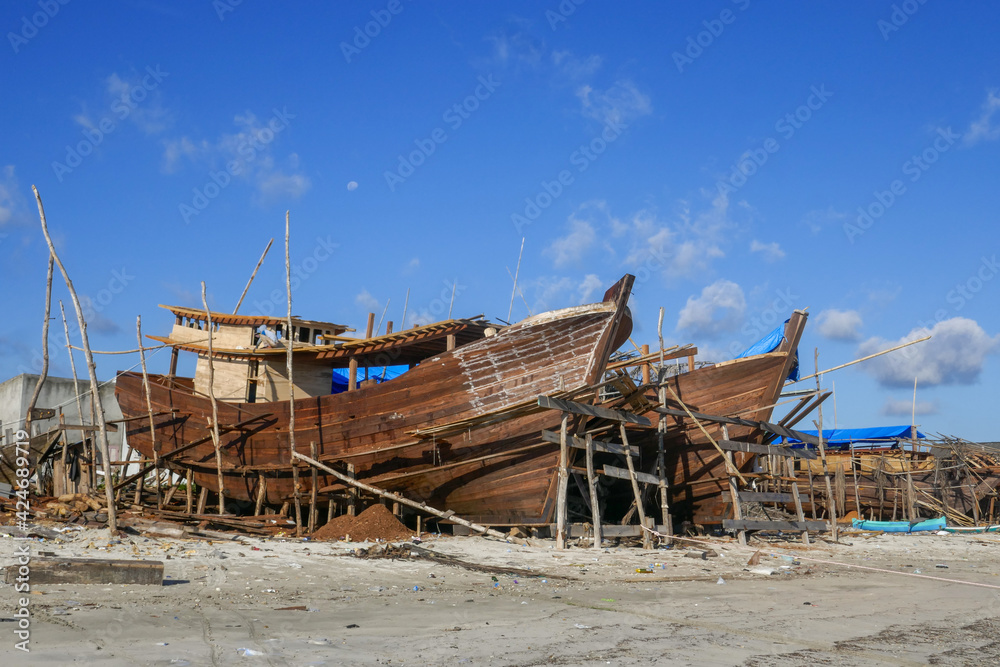 Landscape view of Bugis traditional shipyard with wooden phinisi boats in Tanah Beru, Bulukumba, South Sulawesi, Indonesia