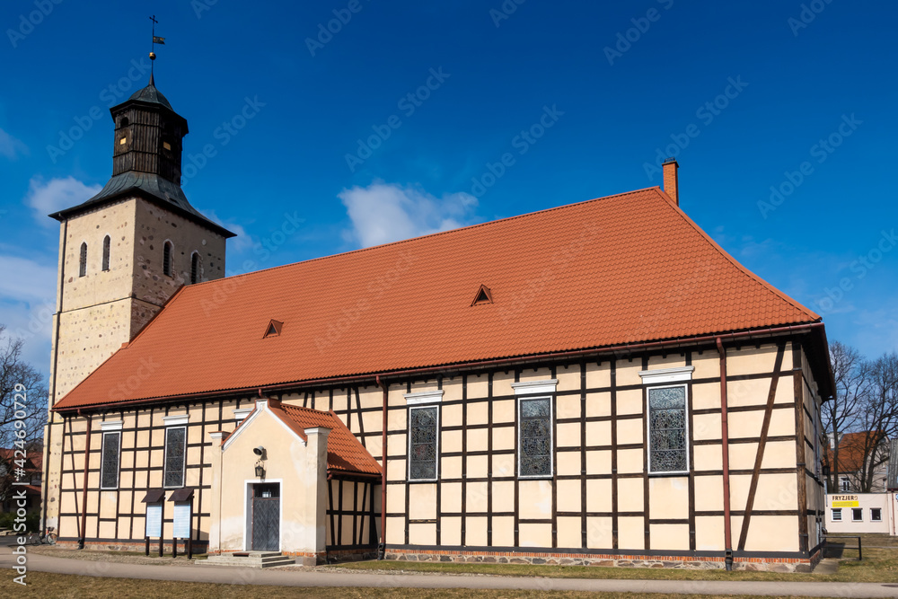 An example of a half-timbered wall (Prussian Wall)  used in religious architecture. Made on a sunny day. object against the blue sky. City of Pisz, Poland
