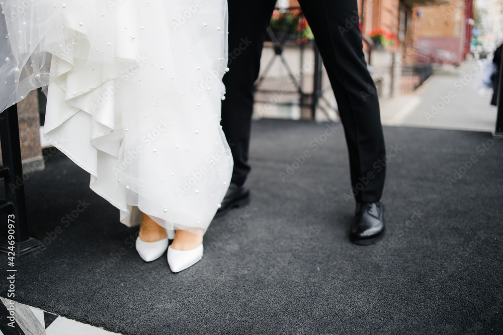 the feet of the bride and groom in shoes