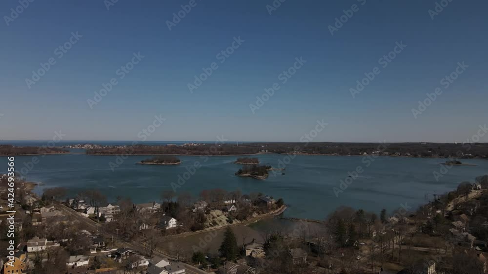Left to right pan of Crow Point, a neighborhood in Hingham, MA USA, showing the waterfront and harbor islands. Drone, aerial, panning. Left to right pan of Crow Point, a neighborhood in Hingham, MA USA, showing the waterfront and harbor islands. Drone, aerial, panning.