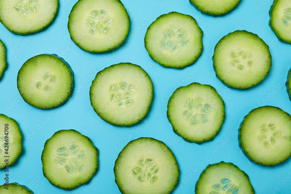 Fresh ripe cucumber slices on blue background Fresh ripe cucumber slices on blue background