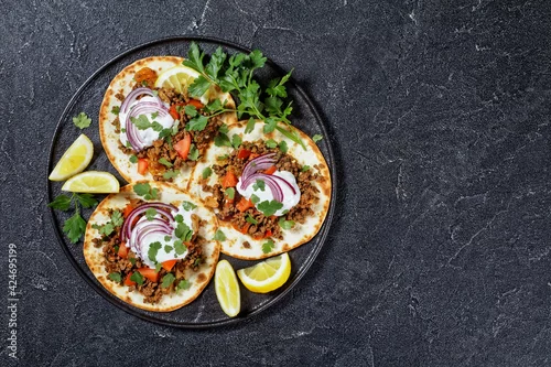 Obraz ground Lamb Flatbreads with yogurt, top view