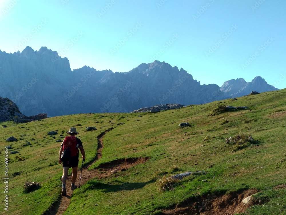 A mountaineer hiking near Vega de Ario, in The Anillo of Picos de Europa, Spain