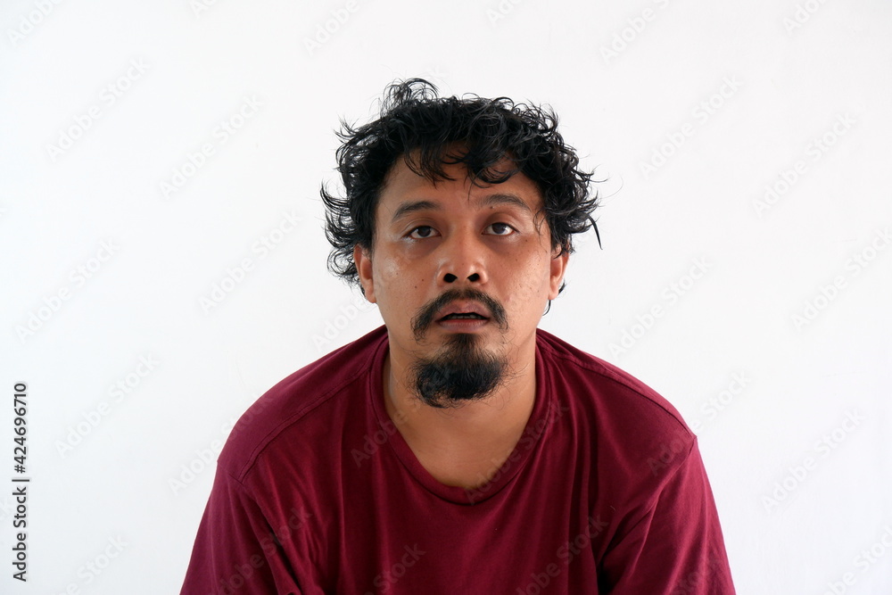 stressed asian man looking at camera isolated in white stressed asian man looking at camera isolated in white