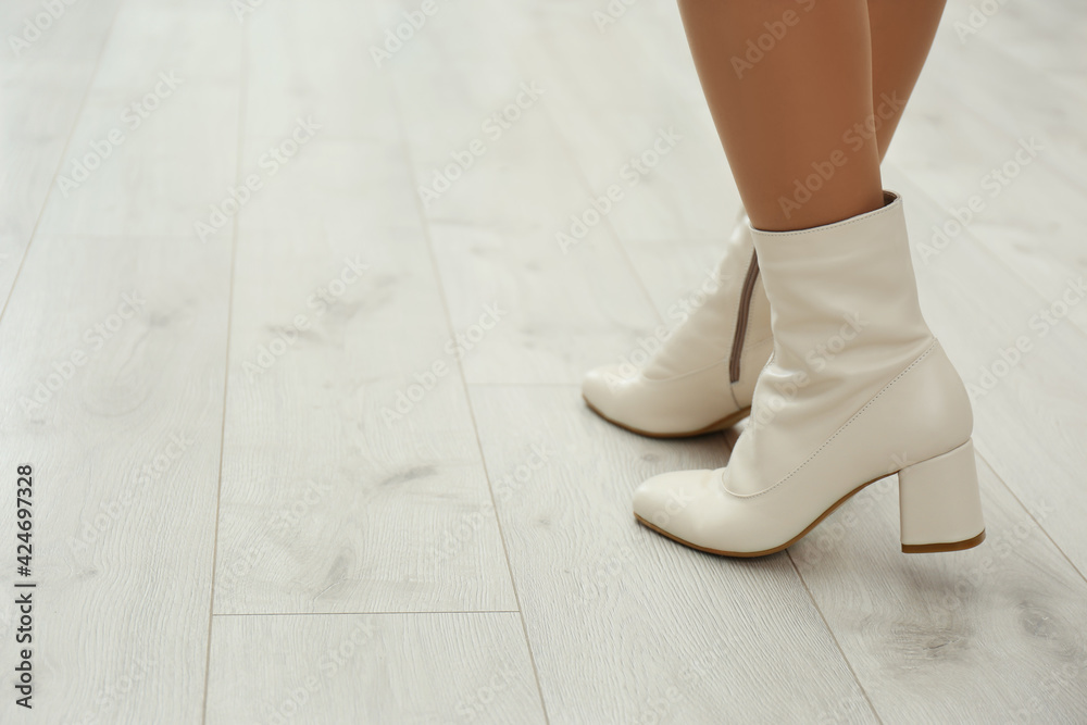 Woman wearing stylish leather shoes indoors, closeup. Space for text