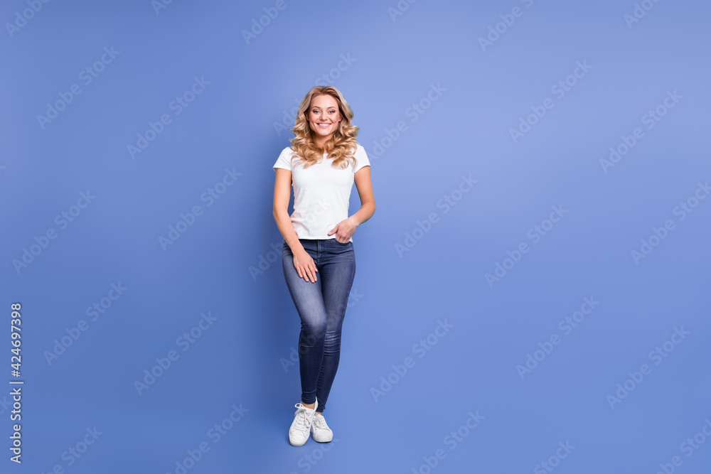 Full length body size view of attractive cheerful wavy-haired girl wearing cozy clothes isolated over blue color background Full length body size view of attractive cheerful wavy-haired girl wearing cozy clothes isolated over blue color background