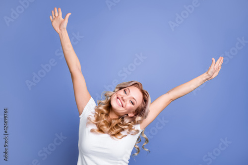 Photo of young cheerful attractive woman happy positive smile hands up excited rejoice isolated over blue color background