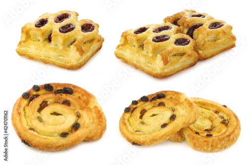 freshly baked traditional Dutch pastry filled with strawberry jam and apple cinnamon rolls on a white background