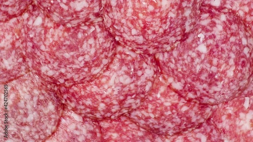 Slices of salami  background. sausage cut. uncooked smoked.  
