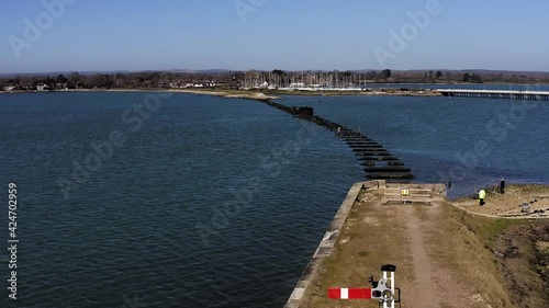 The remains of the Hayling Island Railway Bridge aerial of this wooden bridge that was closed in 1963 and was a branch line from Havant to Hayling Island, the old railway signal  is still in place. photo