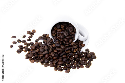 fresh coffee beans in a cup with a saucer on a white background 