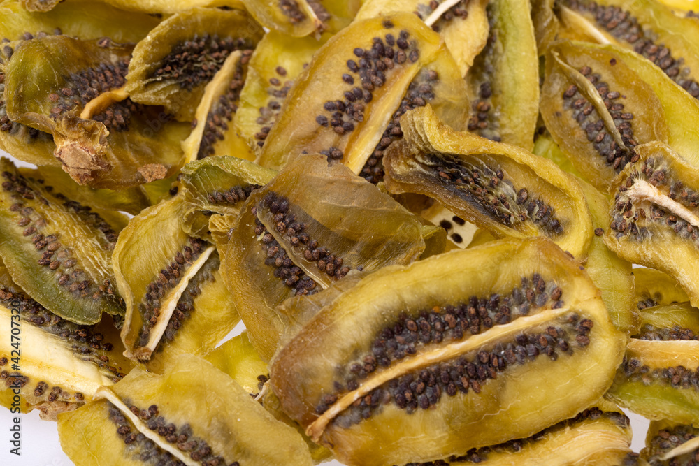 Fototapeta premium Dried kiwi fruit slices. Perfect as a snack, addition to ice cream and other desserts.