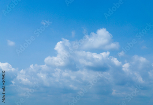 Beautiful view of blue sky with clouds. Beautiful shapes, partly cloudy. Colorful sunset. Natural sky background texture, beautiful color. Bright landscape in the blue sky.