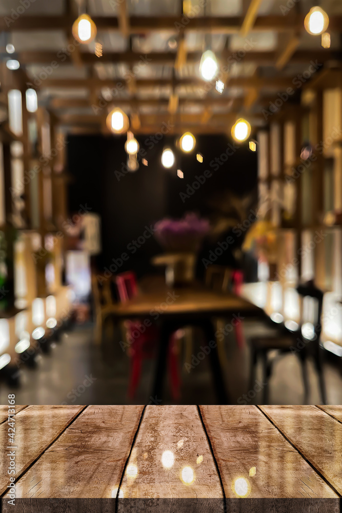 Empty wooden table top with lights bokeh on blur restaurant background. Empty wooden table top with lights bokeh on blur restaurant background.