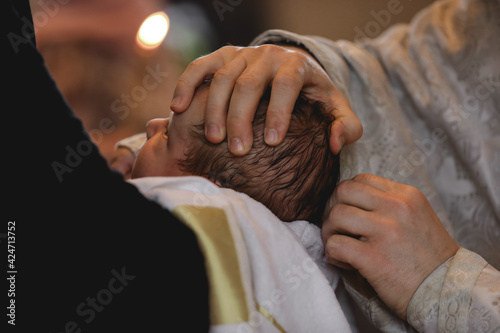 Man holding adorable baby in church during baptism ceremony, closeup photo