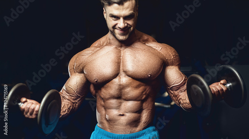 fit man training arm muscles at gym