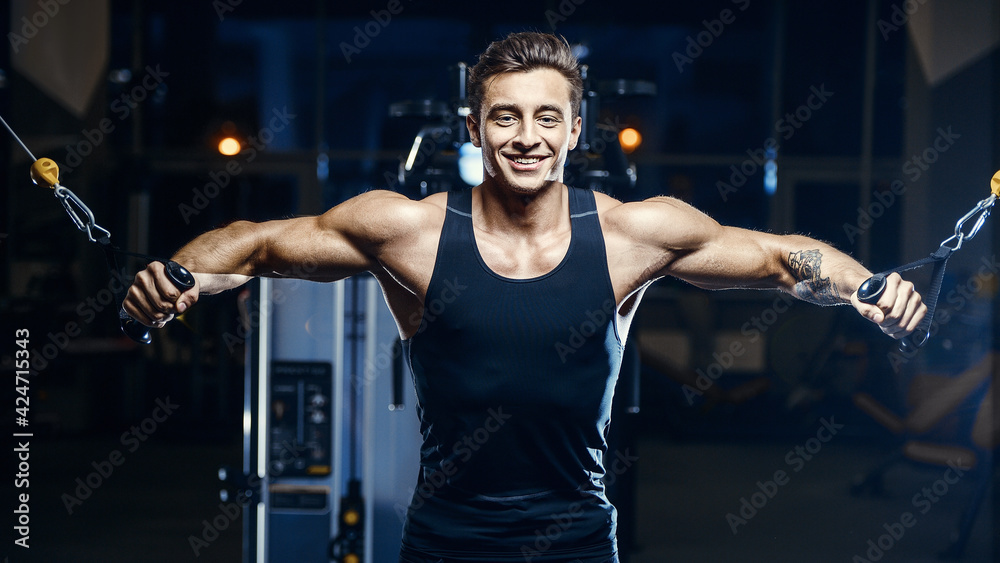 fit man doing cable crossover at gym. fit man doing cable crossover at gym.