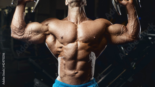 fit man training arm muscles at gym