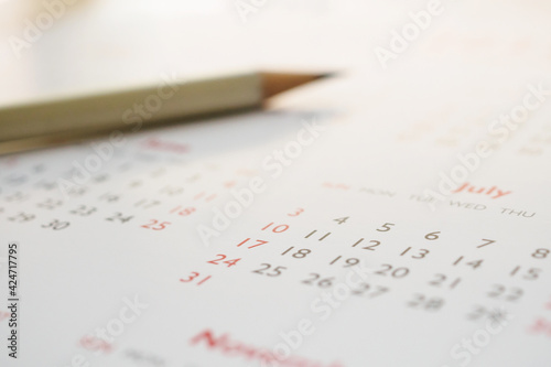white pencil on calendar background business planning appointment meeting concept