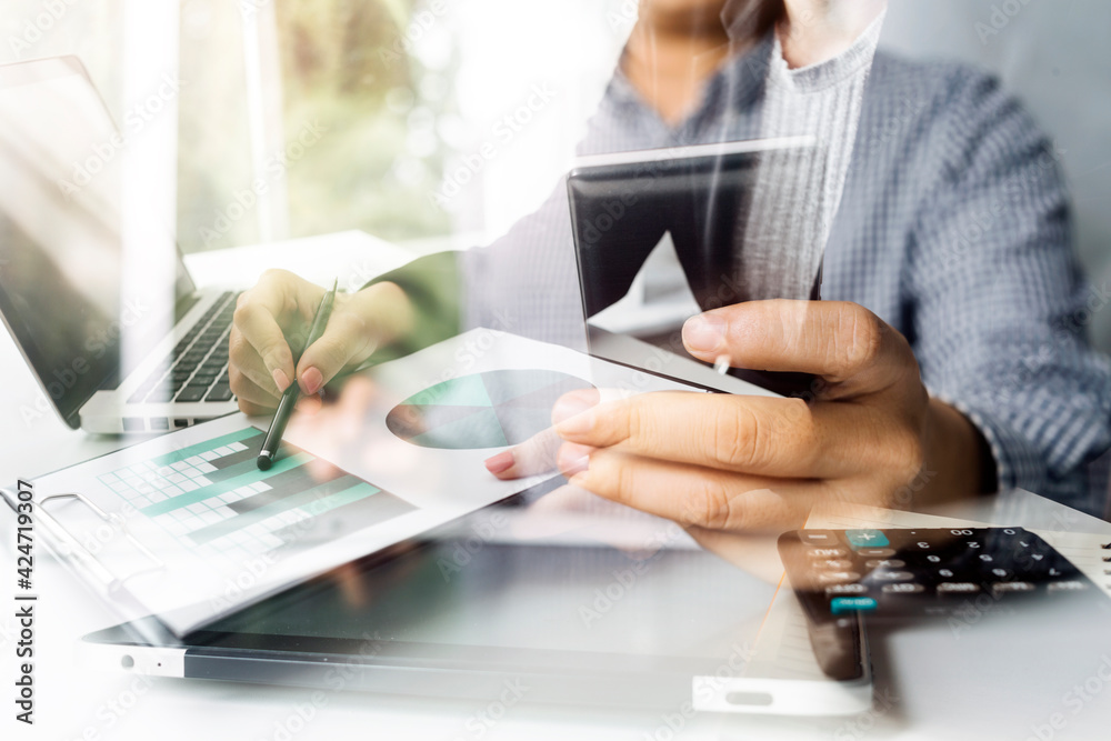 Fototapeta premium Businesswomen hands working with finances about cost and calculator and laptop with tablet, smartphone at office in morning light