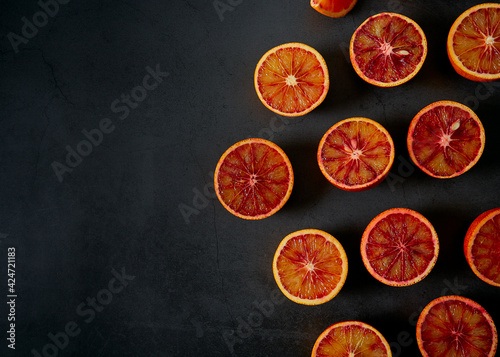 blood oranges on dark stone surface