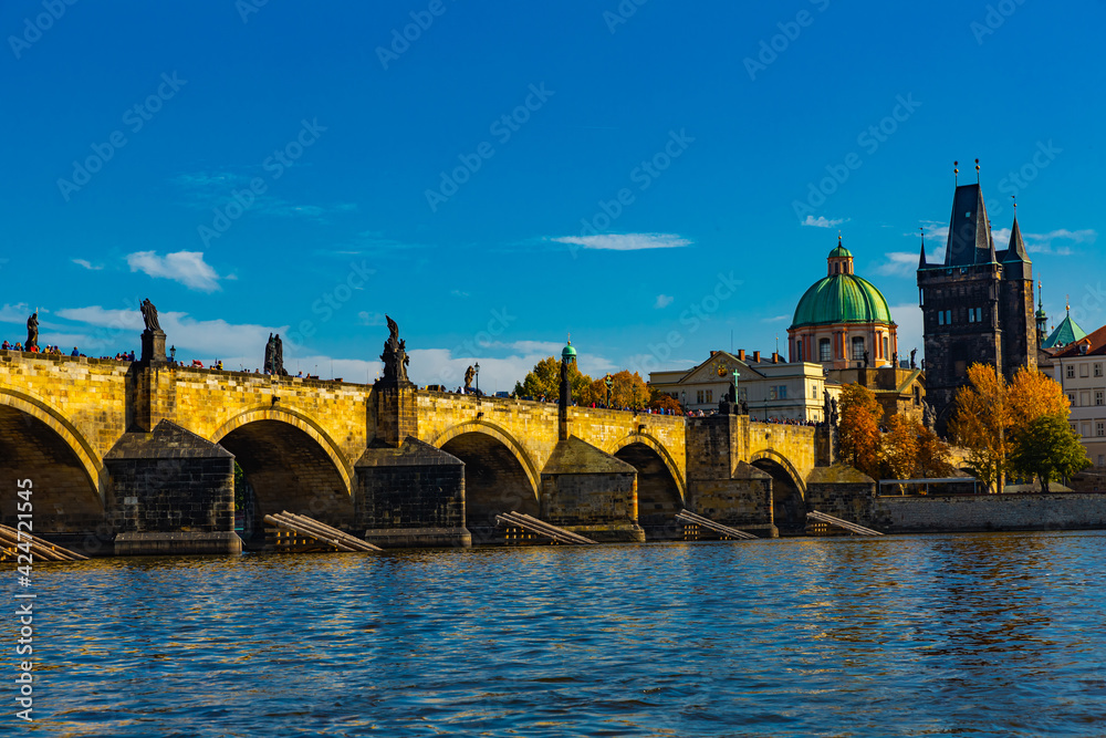 View of Prague, Charles bridge and the Vltava river with tourist boats floating. Czech republic