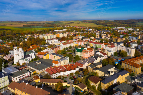 Aerial view of Krnov cityscape overlooking Town hall and St. Martin church on sunny autumn day, Czech Republic