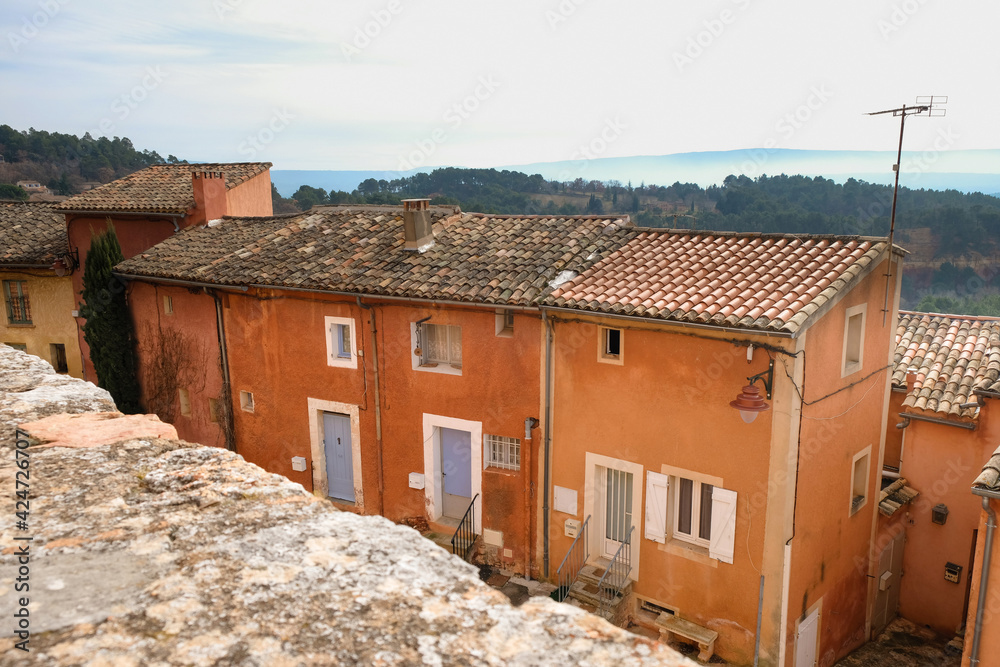 Old houses painted with ocher. Roussillon tourist village. Provence. France.