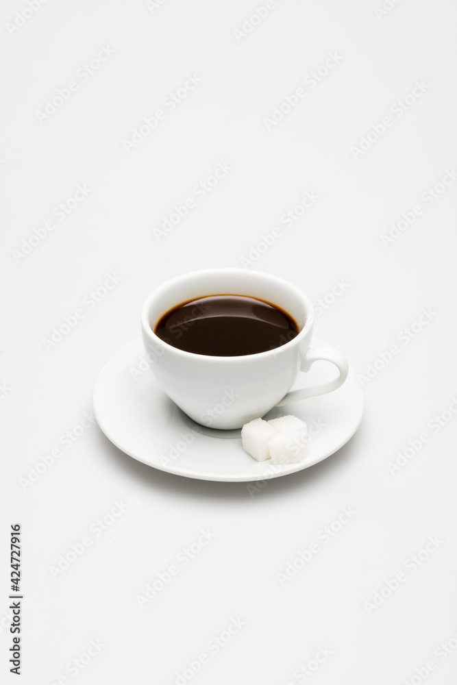 cup of prepared coffee and sugar cubes on saucer on white cup of prepared coffee and sugar cubes on saucer on white
