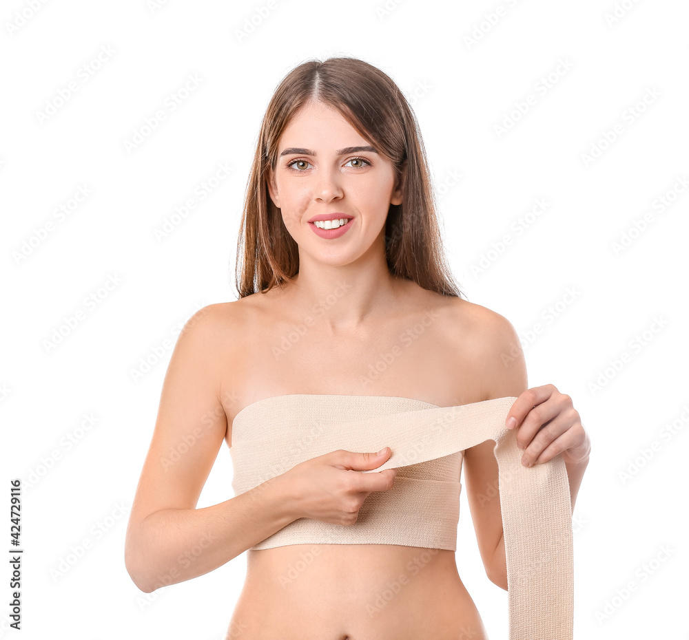 Plakat Woman with bandage on her chest against white background. Breast augmentation concept