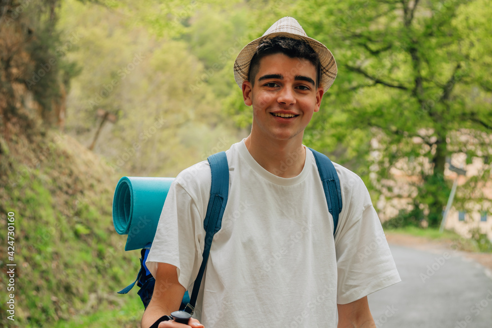 smiling teenage man with backpack hiking smiling teenage man with backpack hiking