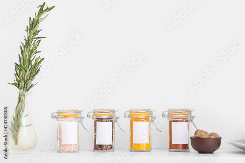 Fototapeta Naklejka Na Ścianę i Meble -  Jars with different spices on table in kitchen