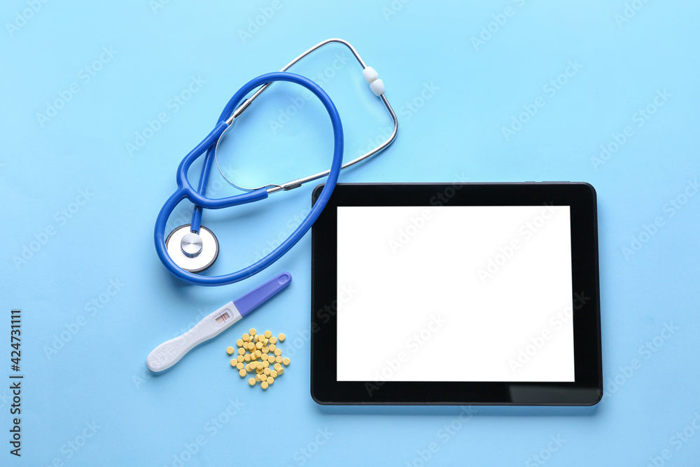 Stethoscope, folic acid pills and tablet computer on color background Stethoscope, folic acid pills and tablet computer on color background